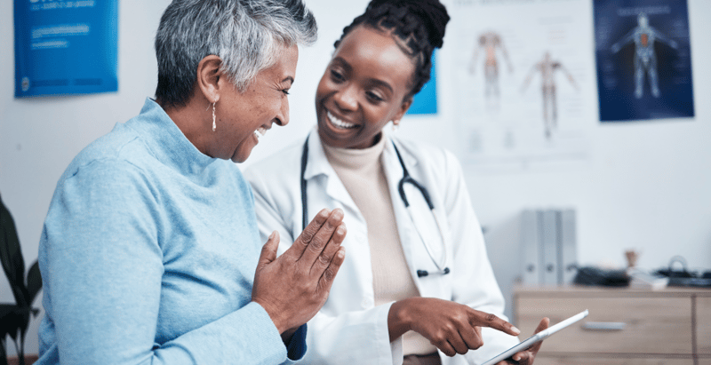 black-woman-doctor-and-elderly-patient-with-table-2023-11-27-05-01-04-utc